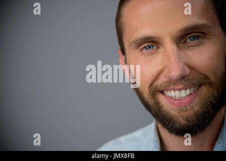 Portrait of handsome man against dark grey background Stock Photo