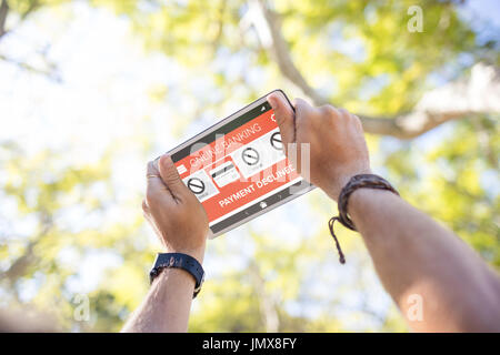 Online banking and payment declined text on phone screen against cropped hands using digital tablet Stock Photo