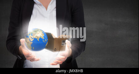 Businesswomans hands presenting against black wall Stock Photo