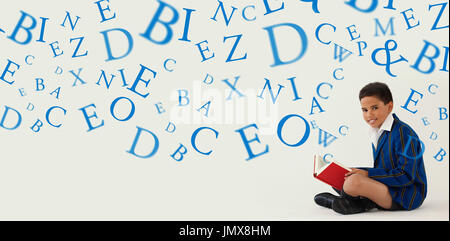letters against schoolboy reading book on white background Stock Photo