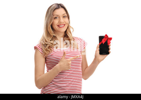 Young woman showing a phone with a red ribbon and pointing isolated on white background Stock Photo