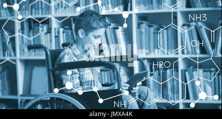 Composite image of chemical structure against disabled schoolboy using digital tablet in library Stock Photo
