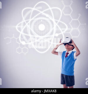 Atomic structure against black background against schoolboy using virtual reality headset Stock Photo