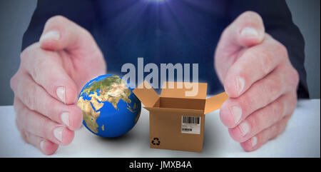 Businessman with hand out  against dark room Stock Photo