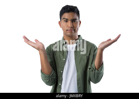 Portrait of frowning man gesturing against white background Stock Photo