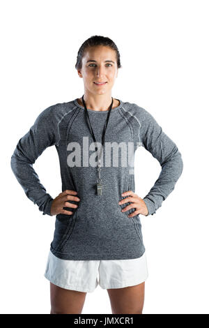 Portrait of female rugby coach with hands on hip standing against white background Stock Photo