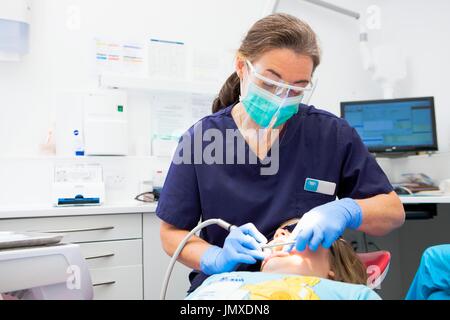 Patient at dentist's Editorial use only   MODEL RELEASED. Dentist checking patient's teeth. Stock Photo