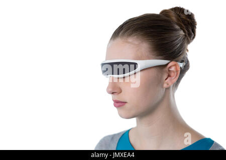 Teenage girl using virtual reality glasses against white background Stock Photo