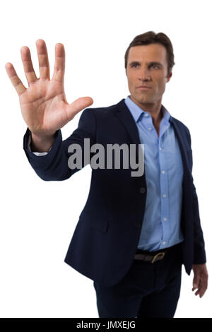 Businessman touching the invisible screen against white background Stock Photo