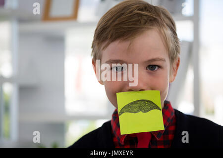 Boy as business executive sleeping in office Stock Photo