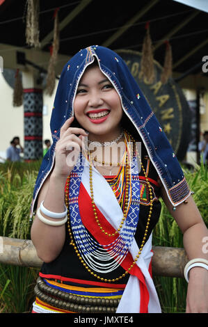 KOTA KINABALU, MALAYSIA - MAY 30, 2015: Candid shot of a smiling Kadazan Dusun girl wearing colorful traditional costume during Sabah Harvest festival Stock Photo