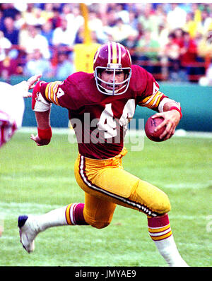 Washington Redskins running back John Riggins (44) with a host of Detroit  Lions defenders hanging on makes a gain in NFC play-off action between the  Lions and Skins, Saturday, Jan. 8, 1983