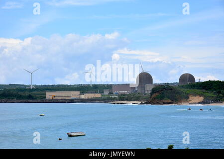 This is a nuclear power plant in South Taiwan with three wind powered windmills behind them to make the public happy. Stock Photo