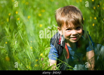 Beautiful blonde boy in the grass Stock Photo