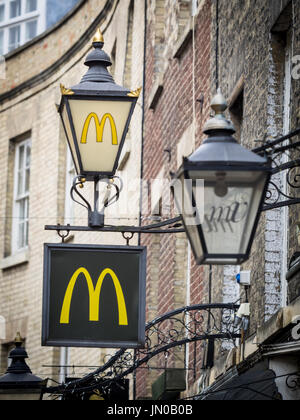 Ornate McDonalds restaurant sign and lamp in a classy historic street in central Cambridge UK Stock Photo