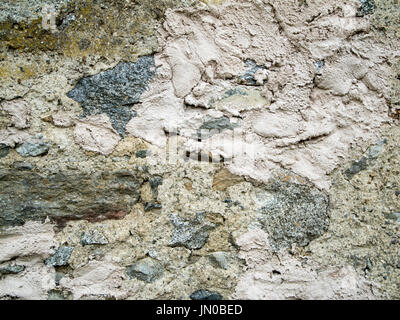 Format-filling view of a rough wall walled out of different fraction stones. Stock Photo