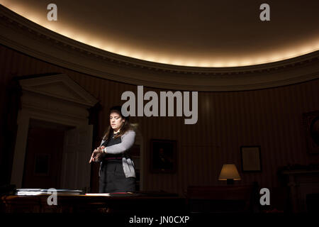 United States President Barack Obama's Personal Secretary Katie Johnson stands in a beam of sunlight in the Oval Office, December 21, 2010.  .Mandatory Credit: Pete Souza - White House via CNP