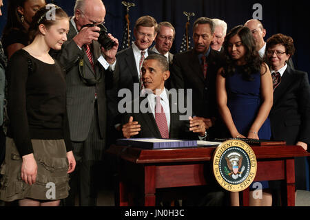 U S President Barack Obama C Is Surrounded By Lawmakers And Family Members Of Slain Police Officers As He Signs The Rafael Ramos And Wenjian Liu National Blue Alert Act Into Law In