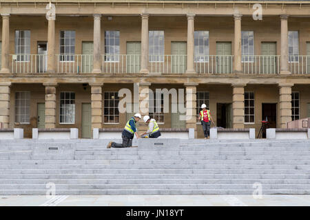 Halifax, UK. 28th July, 2017. Workers put the finishing touches to renovations to the Piece Hall in Halifax, England. The Grade-I listed building has undergone a two-year restoration costing £19 million and will re-open to the public on Yorkshire Day (1 August) 2017. Credit: Stuart Forster/Alamy Live News Stock Photo