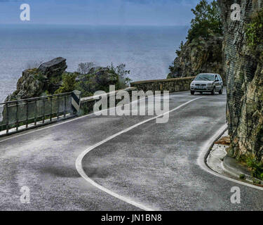 Amalfi Coast Road, Sorrentine Peninsula, Italy. 13th Oct, 2004. A car navigates a hairpin bend along the popular scenic Amalfi Coast road famous for its landscape of sheer cliffs and rugged shoreline views. Considered the most striking stretch of coastline in Italy, it is a popular tourist and holiday destination. Credit: Arnold Drapkin/ZUMA Wire/Alamy Live News Stock Photo