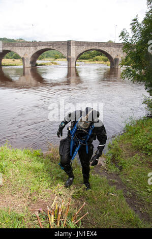 Builth Wells, Powys, Wales, UK. 29th July 2017. A diver emerges from the muddy waters of The river Wye. Two Specialist Search Units are seen on the banks of the River Wye at Builth Wells, Powys, Wales, UK. The units - South Wales Police Specialist Search Unit and Devon & Cornwall (D Section Force Support Group Marine Counter Terrorism & Underwater Search Unit) together comprising a total of five divers, continue the search for missing teenager, nineteen-year-old James Corfield, in Builth Wells, Powys, Wales, UK. and along the river Wye. Credit: Graham M. Lawrence/Alamy Live News Stock Photo