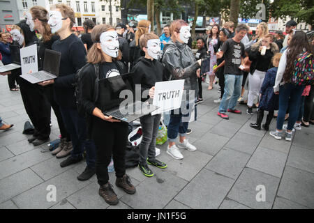 London UK 29 July 2017 People wearing Guy Fawkes masks,promoting veganism and animal welfare, with tablets in their hands showing horrific footage of animal agriculture practice.Graphic footage of animals suffering while been slaughter ,the faceless people holding the tablets forming a square or a cube ,with the word The Truth, don't say a word, dont utter a sound, all is said with the images.@Paul Quezada-Neiman/Alamy Live News Stock Photo