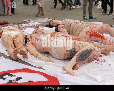 London, UK. 29th July, 2017.Say no to skinning dogs alive hold a creative demonstration as volunteers wear flesh costumes to create a pile of carcasses outside The National Gallery Credit: WFPA/Alamy Live News