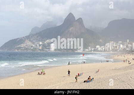Rio de Janeiro, Brazil, July 29, 2017: Rio de Janeiro is sunny and partly cloudy on Saturday. Even though it is winter, the heat allows many sunbathers and surfers to enjoy the beach. In this image, beaches of Ipanema, Arpoador and Copacabana. Stock Photo