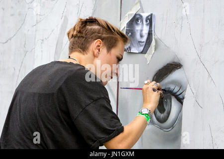 Bristol, UK. 29th July, 2017. An artist is pictured in South Street Park Bedminster as she starts creating her artwork for the festival. Upfest is Europe's largest free, street art & graffiti festival and is now in its ninth year. Credit: lynchpics/Alamy Live News Stock Photo