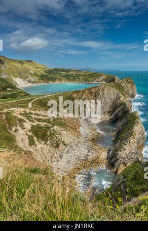 The small coves of Stair Hole in the foreground and Lulworth Cove at the rear on the Jurassic Coast UNESCO World Heritage Site in Dorset UK Stock Photo
