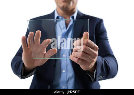 Mid section of businessman using a glass digital tablet against white background Stock Photo