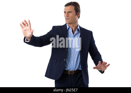 Businessman touching the invisible screen against white background Stock Photo
