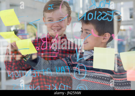 Kids as business executives discussing over whiteboard in office Stock Photo