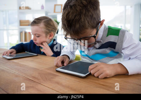 Boy as business executive using digital tablet in office Stock Photo