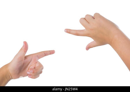 Close-up of kid hands gesturing against white background Stock Photo