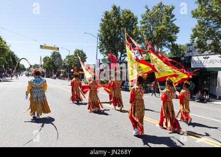 Seattle, Washington: Chinese Community Girls Drill Team performs at the West Seattle Grand Parade. The annual parade, hosted by the West Seattle Rotar Stock Photo