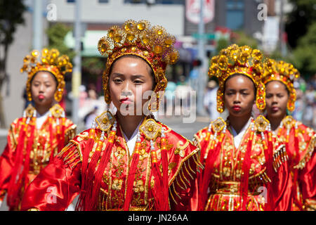 Seattle, Washington: Chinese Community Girls Drill Team performs at the West Seattle Grand Parade. The annual parade, hosted by the West Seattle Rotar Stock Photo