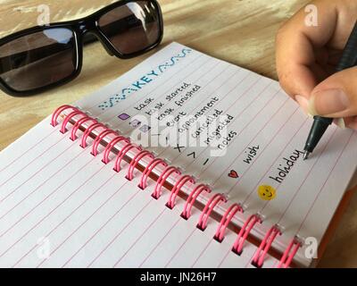 Writing the key of a bullet journal, to include holiday time Stock Photo