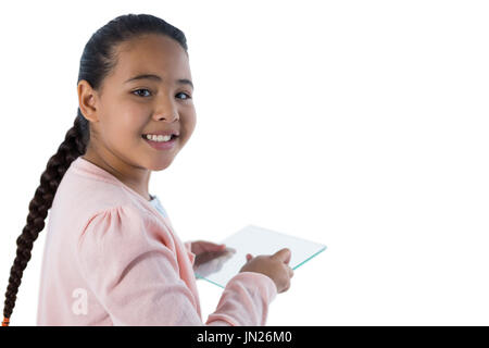 Portrait of girl using glass digital tablet against white background Stock Photo