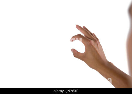 Man pretending to touch an invisible screen against white background Stock Photo