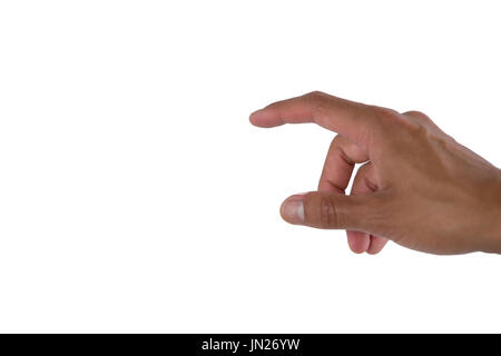 Man pretending to touch an invisible screen against white background Stock Photo