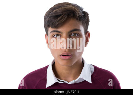 Portrait of shocked teenage boy standing against white background Stock Photo