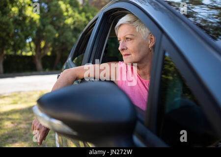 Thoughtful senior woman sitting in a car Stock Photo