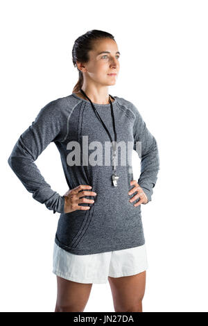 Confident female rugby coach with hands on hip standing against white background Stock Photo