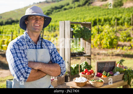 Portrait of farmer standing with arms crossed in vineyard Stock Photo