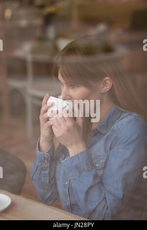 Beautiful woman having coffee in the cafe Stock Photo