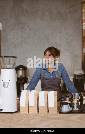 Beautiful waitress standing in cafe Stock Photo