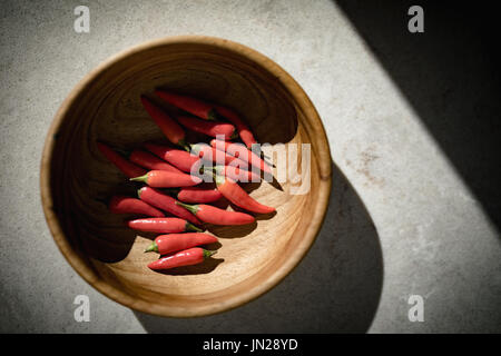 Close-up of red chillies in wooden bowl Stock Photo