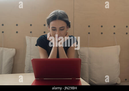 Female owner using laptop while sitting at table in cafe Stock Photo