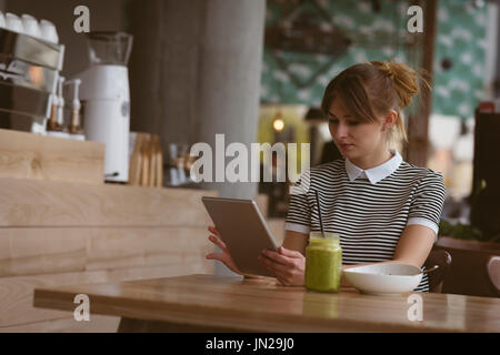 Beautiful woman using digital tablet in the cafe Stock Photo